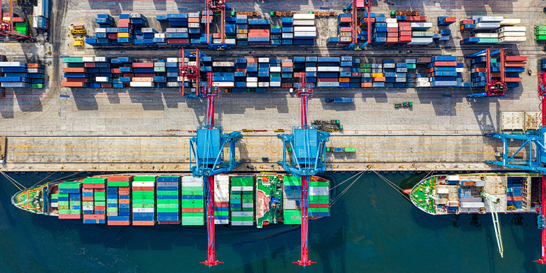 Photo of cargo ship unloading containers at a shipping port